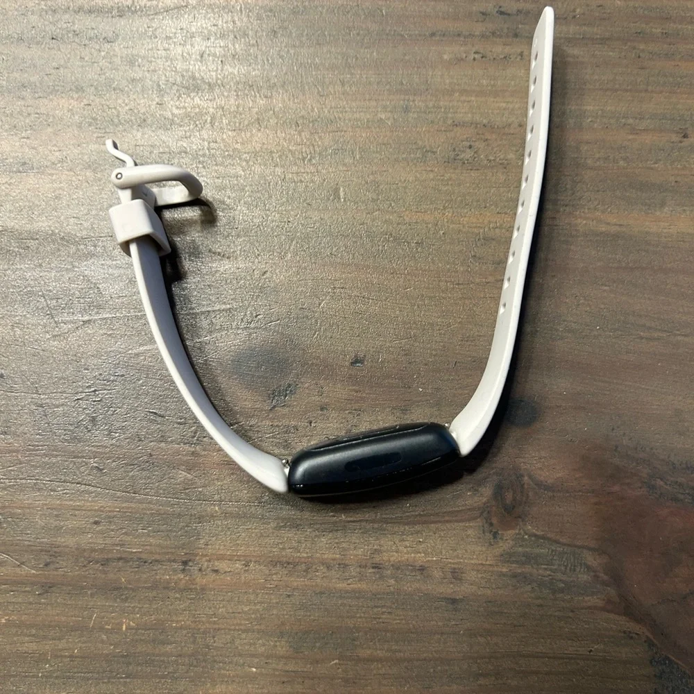 Black and White Fitness Tracker (FitBit with charger)